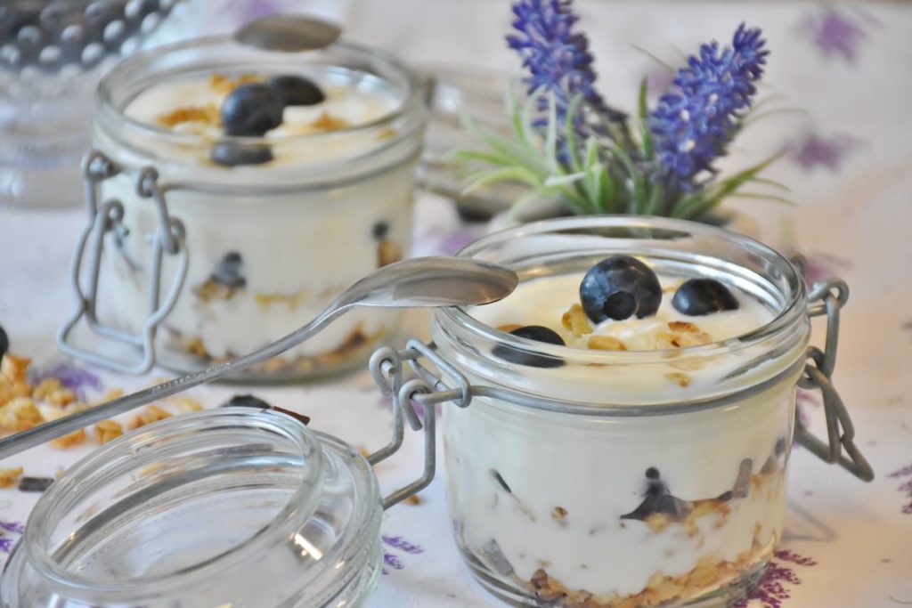 Image of jars full of probiotic yogurt with blueberries on a table