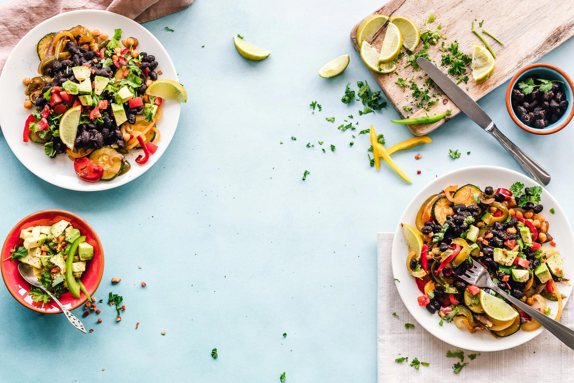 Image of plates on a blue table with healthy food