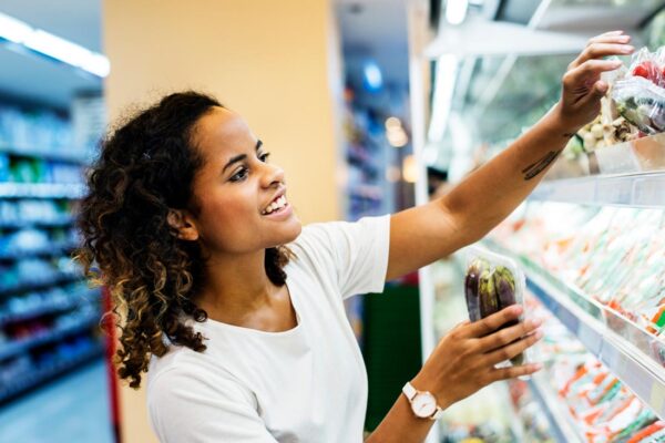 Image of a woman shopping at a grocery store for DASH diet and Mediterranean diet food