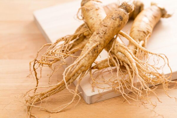 Image of ginseng on a cutting board and wooden table